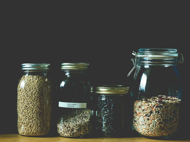 Four clear jars filled with grains