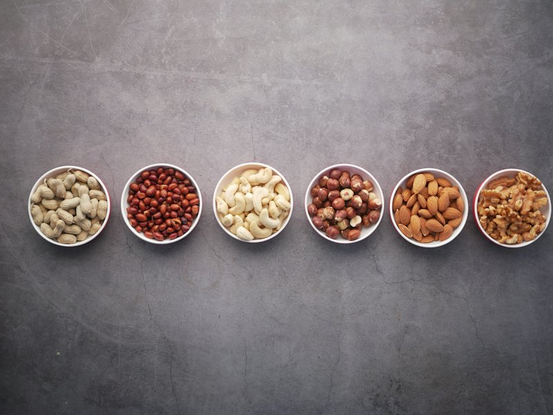 Brown nuts on white ceramic bowls