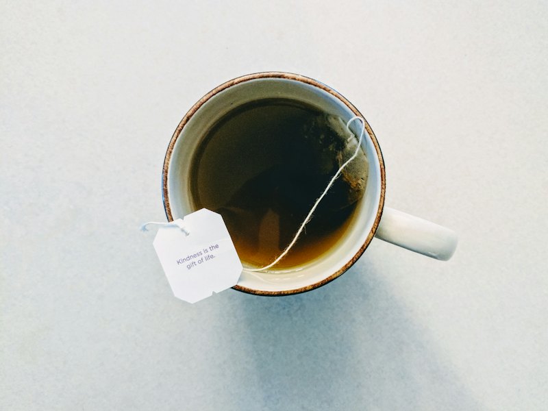 White and red ceramic mug filled with tea