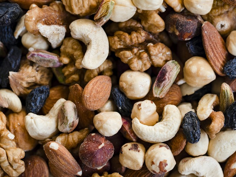 A close-up view of a mixed nut and raisin blend